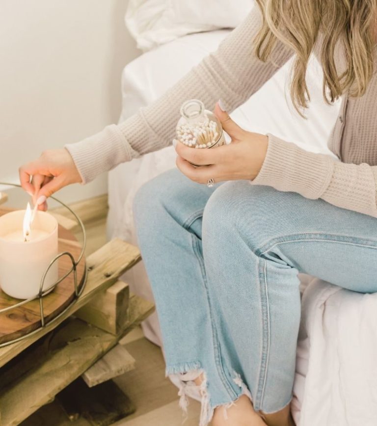 A woman practicing mindfulness in Los Angeles for holistic mental health. She is lighting a candle as a form of therapy.