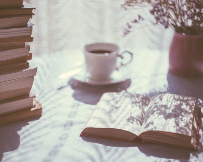 An attachment and anxiety therapy office in Los Angeles. Cup of coffee and book and relaxing pink colors