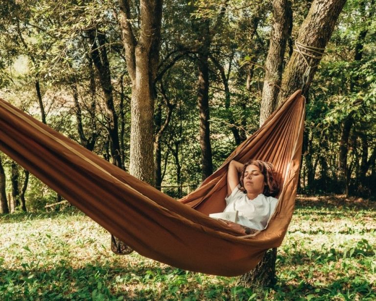 Person relaxing in a hammock during a somatic therapy session in Los Angeles to ease anxiety and stress