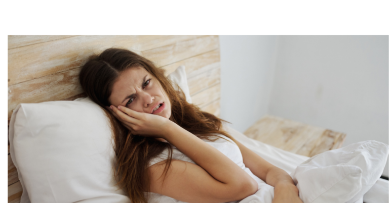 woman trying to find a trauma therapist in los angeles, laying in her bed looking sad.