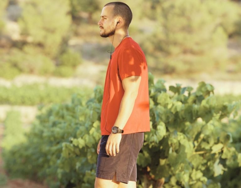 Man in Los Angeles walking to therapy. Orange top, shorts.