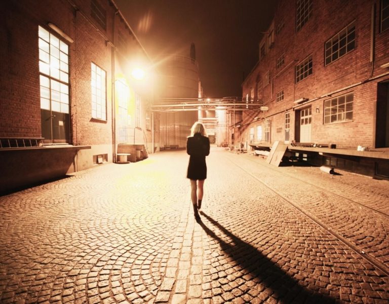 Shadow of woman in Los Angeles at night. She looks secure and confident alone.