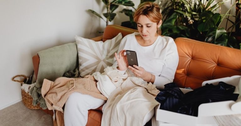 Woman relaxing while getting attachment therapy in Los Angeles. She is on the couch, wearing white clothes, looking relaxed.