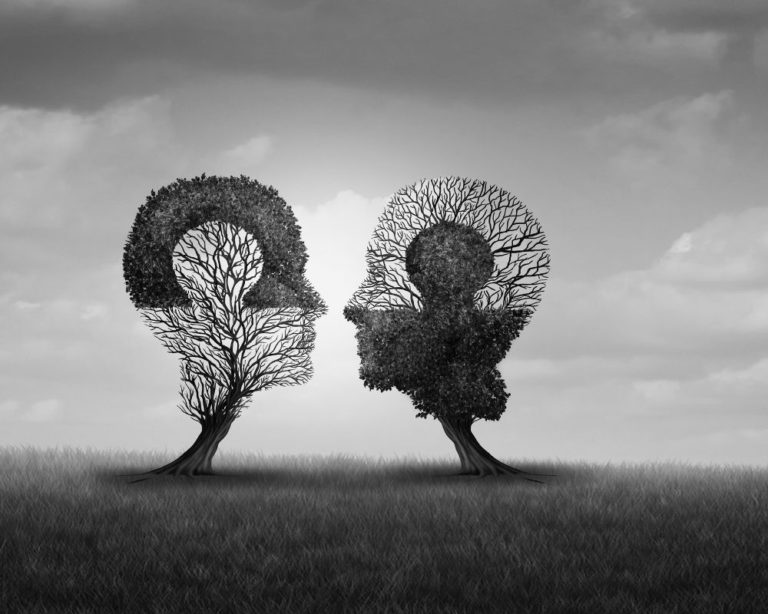 Photo of two trees that look like human heads. Photo is black and white, and represents attachment and somatic therapy website page in Los Angeles