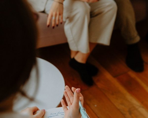 Complex PTSD and trauma therapy office in Los Angeles. Therapist talking to client.