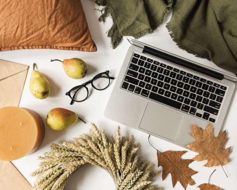 An attachment and somatic therapy office in Los Angeles. A laptop, glasses, and decorations are on the white table