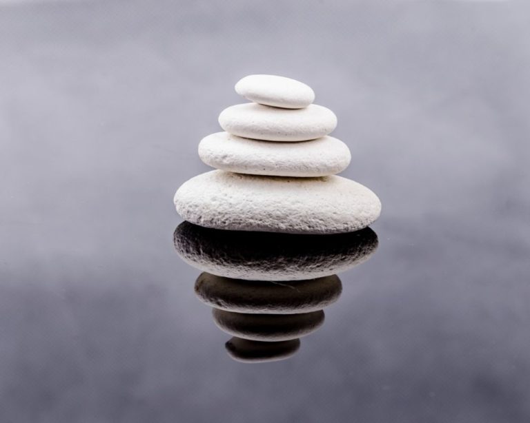 A relaxing stack of rocks on a body of water in Los Angeles. Unity in stacking represents secure attachment that can worked on in therapy.