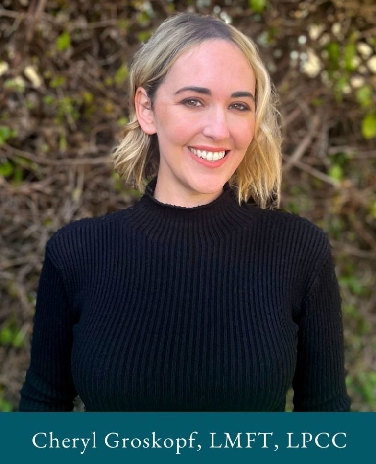 Photo of Cheryl Groskopf, holistic therapist in Los Angeles. Therapist is smiling and wearing black shirt, Los Angeles in the background.