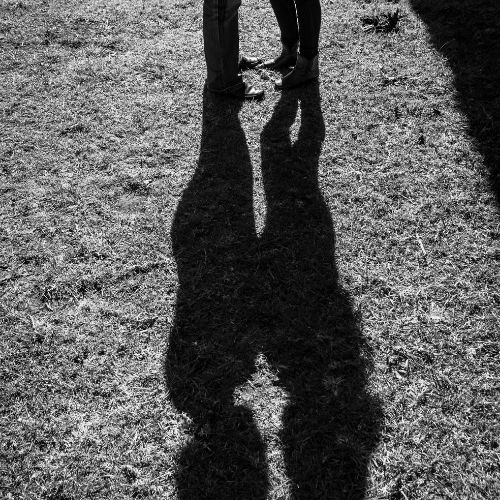 Supportive moment between partners in Los Angeles, demonstrating progress in their journey through fearful avoidant attachment therapy. Photo shows the shadow of the couple on Los Angeles landscape.