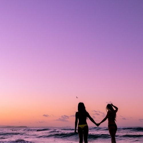 Happy couple doing attachment therapy in LA enjoys a peaceful moment on the beach in Los Angeles