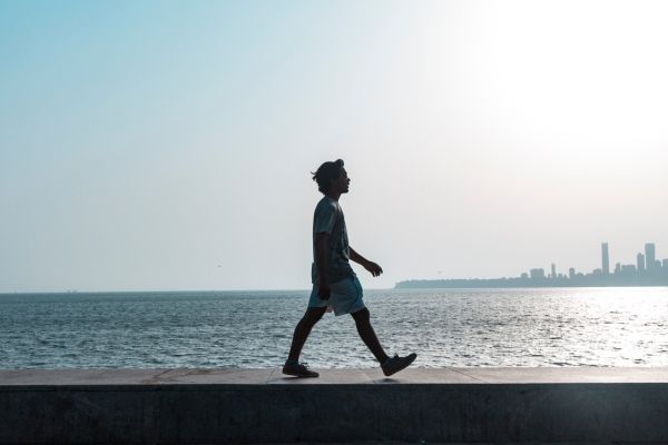 Man walking on a beach in Los Angeles.