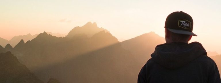 Mountain landscape with sunshine in Los Angeles, and a shadow of a man symbolizing clarity and healing through therapy.