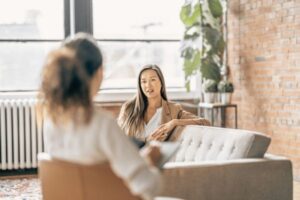 Client sitting in a therapy office, engaging in a session focused on anxiety, attachment, and somatic healing.