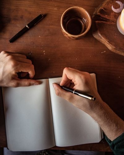 A person journaling in a quiet space, using writing as a tool for self-reflection and emotional healing—an approach we incorporate in trauma therapy in Los Angeles