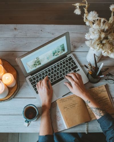 A person using a laptop, their arm visible as they engage in online therapy—reflecting the accessibility and support of virtual trauma therapy in Los Angeles.