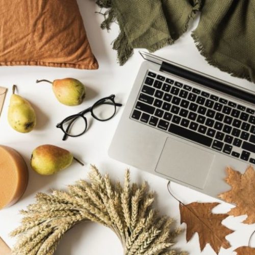 An attachment and somatic therapy office in Los Angeles. A laptop, glasses, and decorations are on the white table