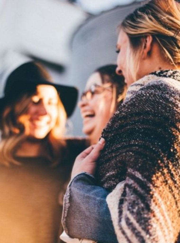 A group of women in Los Angeles talking about therapy in LA. Women look happy and friendly, and are laughing.