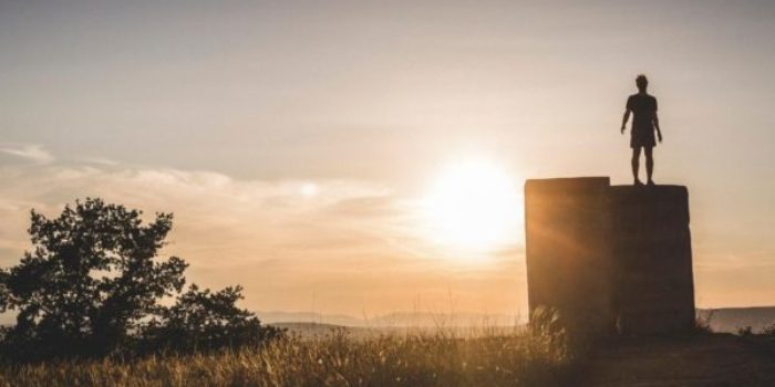 therapy for adult children of narcissistic parents in los angeles: man standing in california desert after receiving therapy. black silhouette and sunset in background